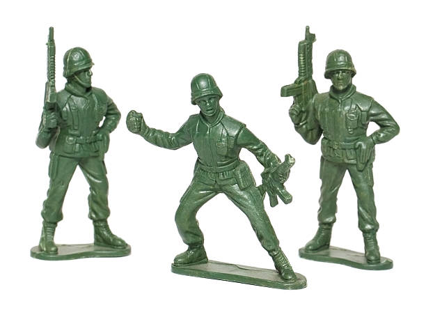 isolated macro toy soldiers studio shot of toy soldiers on white background. All soldiers are carrying guns. One has a grenade. hand grenade photos stock pictures, royalty-free photos & images