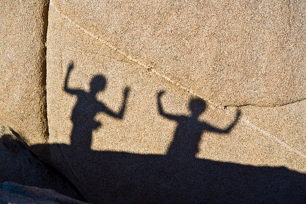istock children playing with shadows on a rock 178566237