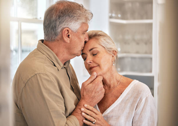 istock Home, kiss and senior couple with love and commitment while together for quality time and bonding. Elderly woman and a man relax in a room with care, support and security in a healthy marriage 1785671214