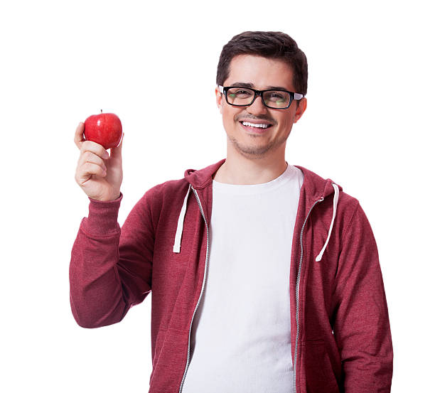 istock Young man in white shirt and with red apple 178567406