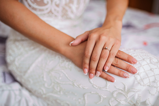 Bride's hands with an engagement ring on them