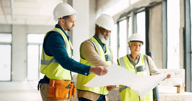 istock Construction, group and discussion with blueprint for building, architecture and site development. Team, engineering and floor plan inspection for industrial design, property maintenance and project 1785677272