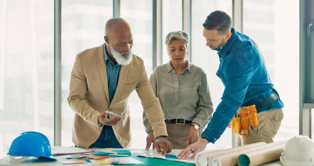 Architecture team, planning and collaboration with color choice, brainstorming design and building floor plan. Engineering, designer or group of people in meeting with project ideas and renovation