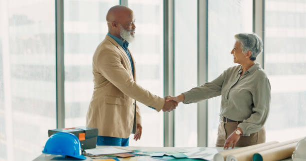 istock Architecture people, handshake and meeting introduction for renovation, design planning and b2b collaboration. Professional designer, contractor and clients shaking hands, building agreement or deal 1785677849