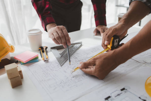 istock The home design architects are reviewing the house plan draft, the project commissioned by the client, and the custom design before delivery. Interior design and decoration ideas. 1785682041