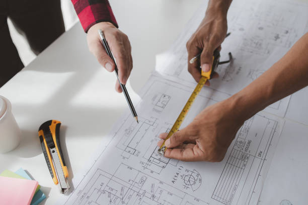 istock The home design architects are reviewing the house plan draft, the project commissioned by the client, and the custom design before delivery. Interior design and decoration ideas. 1785682045