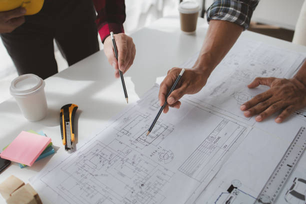 istock The home design architects are reviewing the house plan draft, the project commissioned by the client, and the custom design before delivery. Interior design and decoration ideas. 1785682046