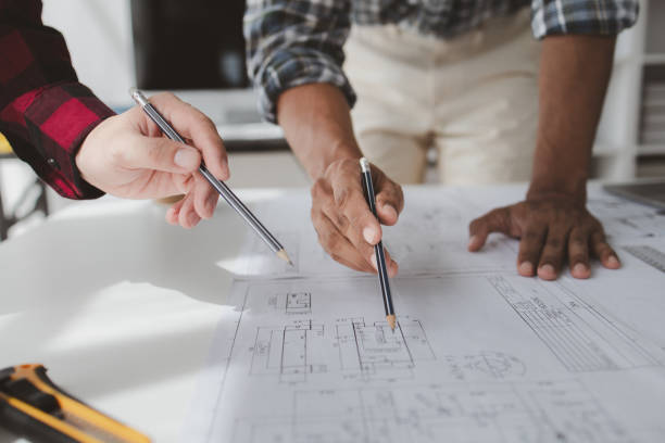 istock The home design architects are reviewing the house plan draft, the project commissioned by the client, and the custom design before delivery. Interior design and decoration ideas. 1785682059