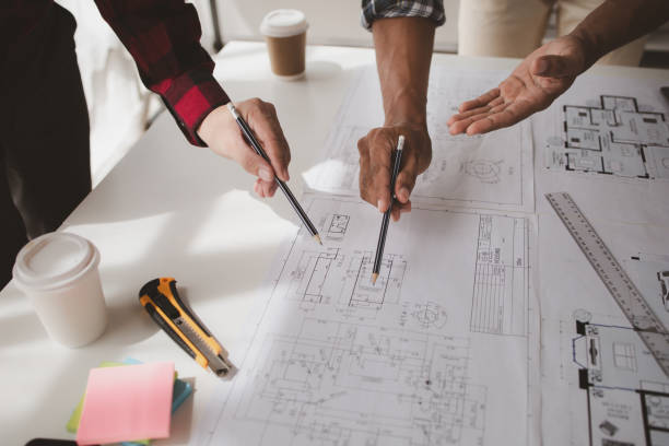 istock The home design architects are reviewing the house plan draft, the project commissioned by the client, and the custom design before delivery. Interior design and decoration ideas. 1785682197