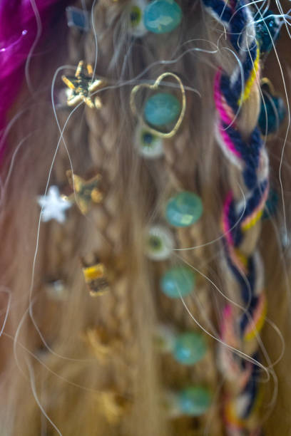 Cropped Hands Of Mother Braiding Daughter Hair