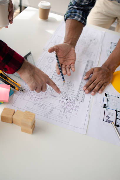 istock The home design architects are reviewing the house plan draft, the project commissioned by the client, and the custom design before delivery. Interior design and decoration ideas. 1785683370