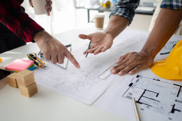 istock The home design architects are reviewing the house plan draft, the project commissioned by the client, and the custom design before delivery. Interior design and decoration ideas. 1785687215
