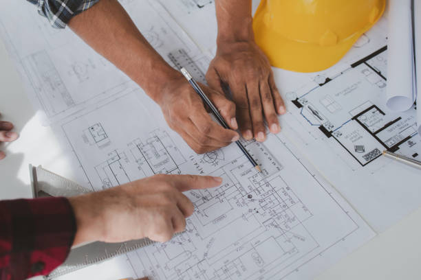 istock The home design architects are reviewing the house plan draft, the project commissioned by the client, and the custom design before delivery. Interior design and decoration ideas. 1785687216
