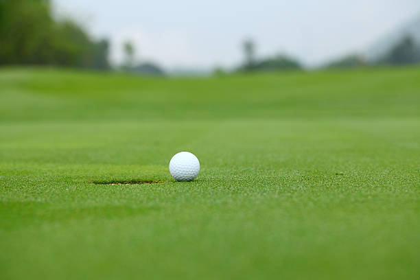 istock On green golf ball near hole 178568724
