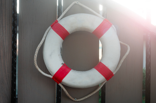 lifebuoy hanging on wooden wall