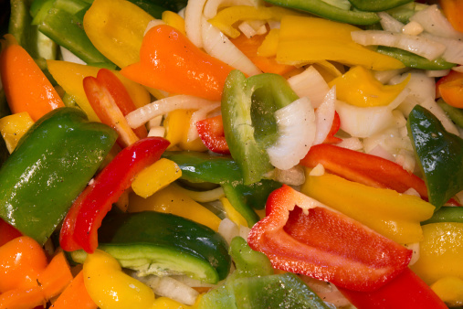 Colorful slices of bell peppers and onions