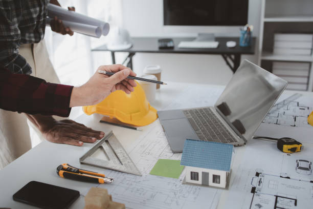 istock The home design architects are reviewing the house plan draft, the project commissioned by the client, and the custom design before delivery. Interior design and decoration ideas. 1785695425