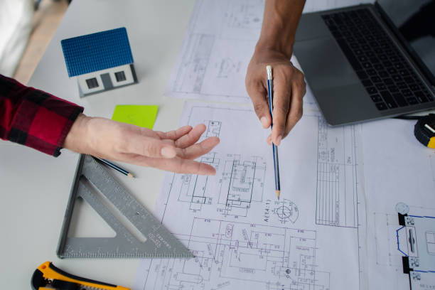 istock The home design architects are reviewing the house plan draft, the project commissioned by the client, and the custom design before delivery. Interior design and decoration ideas. 1785698010