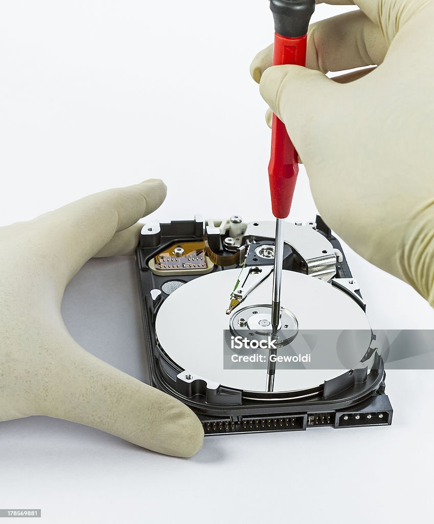 technician with open hard-disk technician with open hard-disk and screwdriver in light background Accessibility Stock Photo