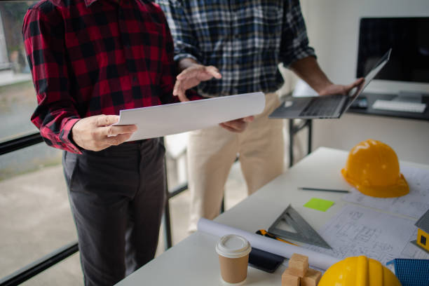 istock The home design architects are reviewing the house plan draft, the project commissioned by the client, and the custom design before delivery. Interior design and decoration ideas. 1785700622