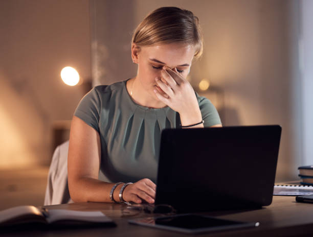 istock Work stress, headache and computer work at night in a office with project report deadline. Working in dark, anxiety and burnout of a corporate worker with a laptop problem and glitch feeling fatigue 1785707612