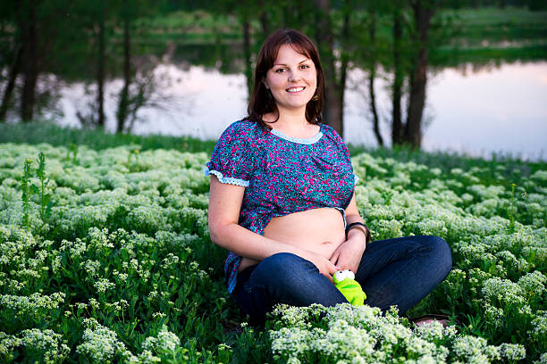 Young pregnant woman on nature.