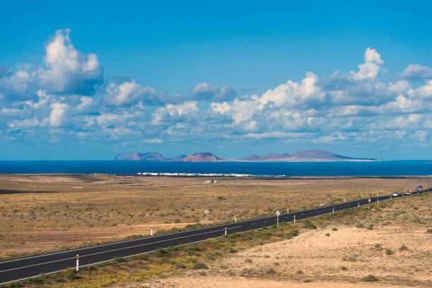 La Graciosa Spain, Canary Islands, La Graciosa: panoramic view of the Graciosa island and Caleta de Famara from Lanzarote island caleta de famara lanzarote stock pictures, royalty-free photos & images