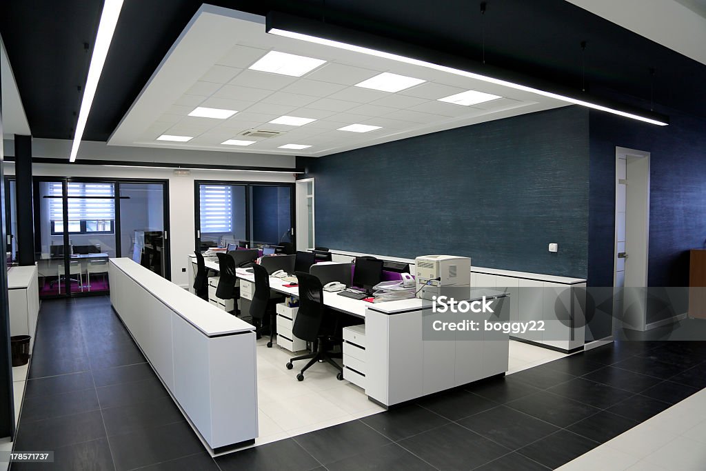 Row of desks in a modern office Modern office interior Architecture Stock Photo