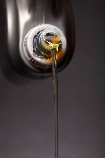 istock Can with car engine oil pouring black background 178571962