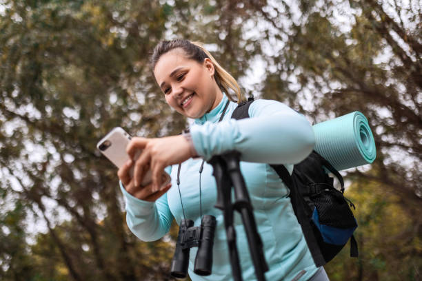 istock Woman in the Forest Utilizing Smartphone 1785727539