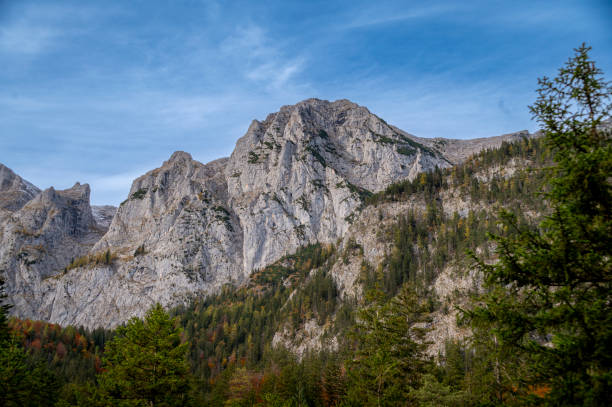 istock High rocky snowy mountain peaks in Alps with autumn forest. 1785728085
