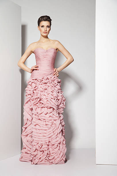 istock young beautiful brunette in pink dress on white 178573160