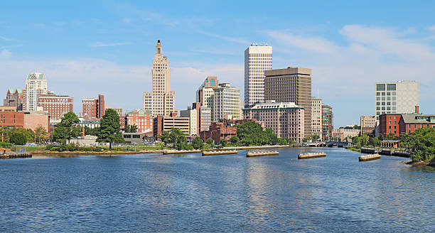 Panoramic skyline of Providence, Rhode Island Panoramic view of the skyline of Providence, Rhode Island, from the far side of the Providence River against a blue sky and white clouds providence rhode island stock pictures, royalty-free photos & images