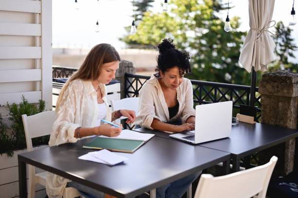 istock Two adult students working in remote location. 1785734110