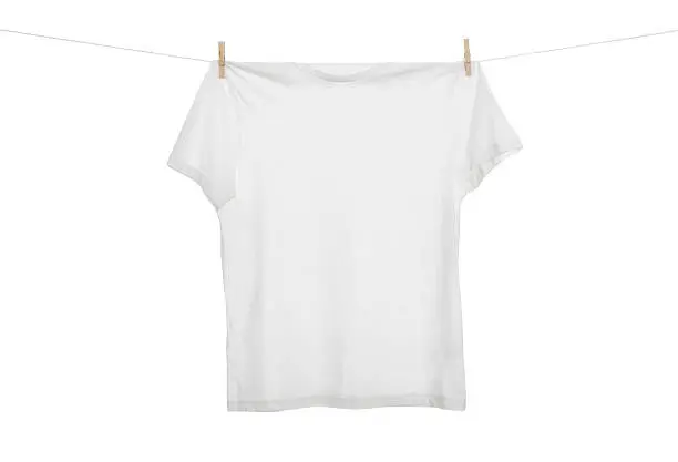 Blank t shirt hanging on the clothes line isolated on white background with copy space