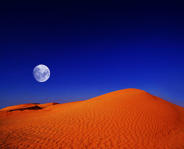 istock at night in the desert of moon so close 178573645