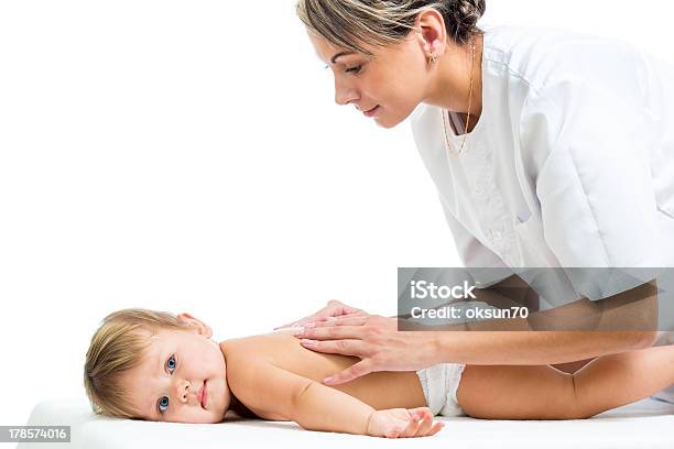 Doctor Massaging Or Doing Gymnastics Baby Girl Stock Photo - Download Image Now - Adult, Baby - Human Age, Baby Girls