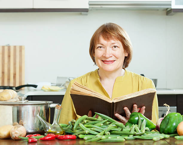 istock mature woman cooking  with  cookery book 178574602