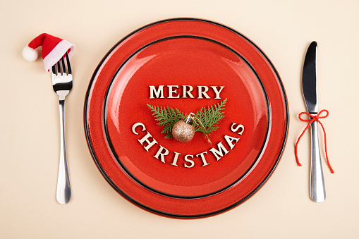 Plate served with fork and knife and Christmas decoration