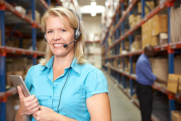istock Smiling woman wearing a headset in a distribution center 178575163