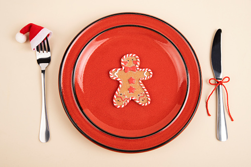 Plate served with fork and knife and Christmas decoration