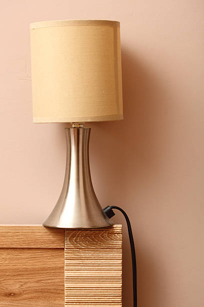 istock lamp on side wooden bed wall background 178575898
