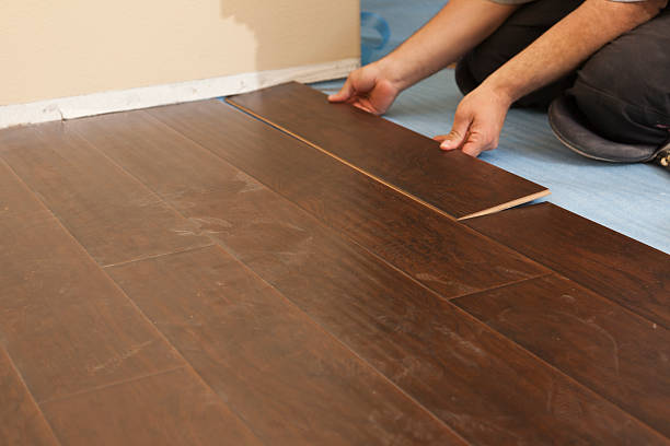 istock Man Installing New Laminate Wood Flooring 178576219