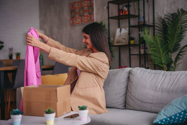 istock Young woman checking out the clothes she bought online 1785766833