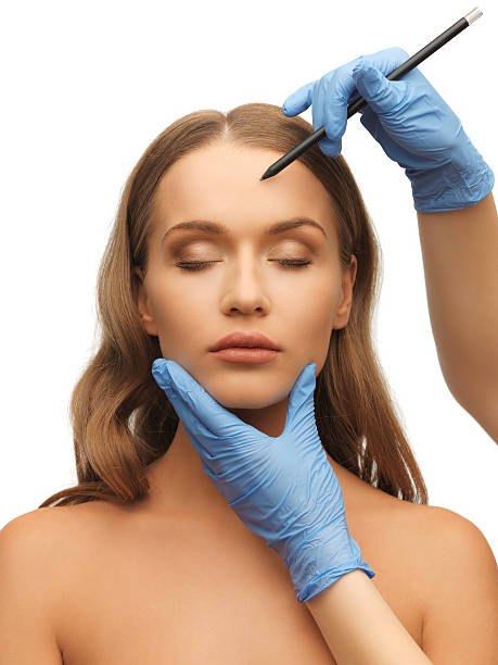 istock woman face and beautician hands 178576978