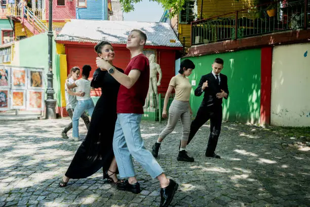 Photo of Street artist woman teaching tango to tourist on Caminito, Buenos Aires, Argentina
