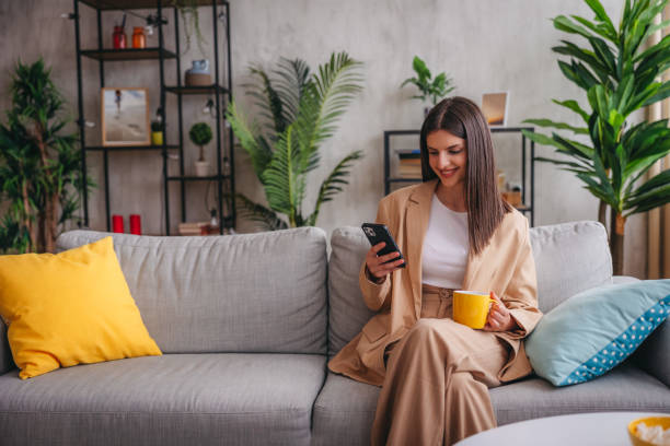 istock Smiling young woman relaxing in the sofa at home 1785771945