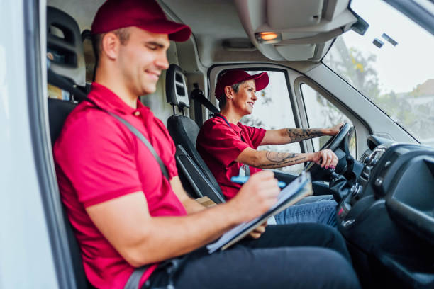 istock Man and woman courier at delivery van 1785773128