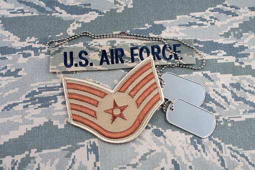 US AIR FORCE branch tape and Staff Sergeant rank patch and dog tags on digital tiger-stripe pattern Airman Battle Uniform (ABU)