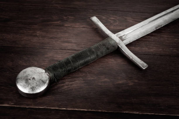 istock Medieval sword on wooden background. 1785778590